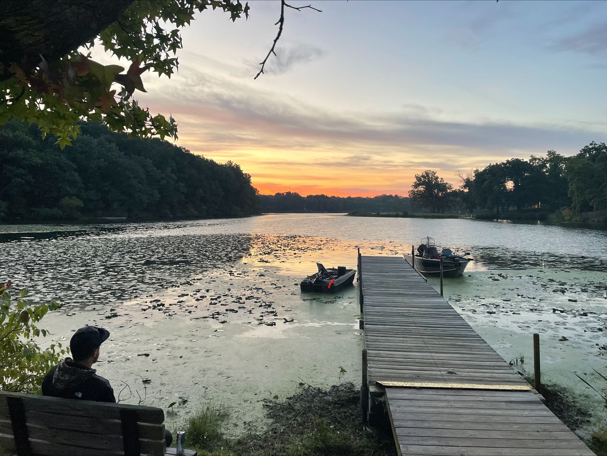A pier on a lake at sunset