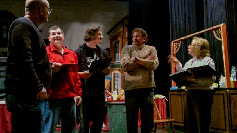 Group of people standing in a semi-circle in various states of a discussion